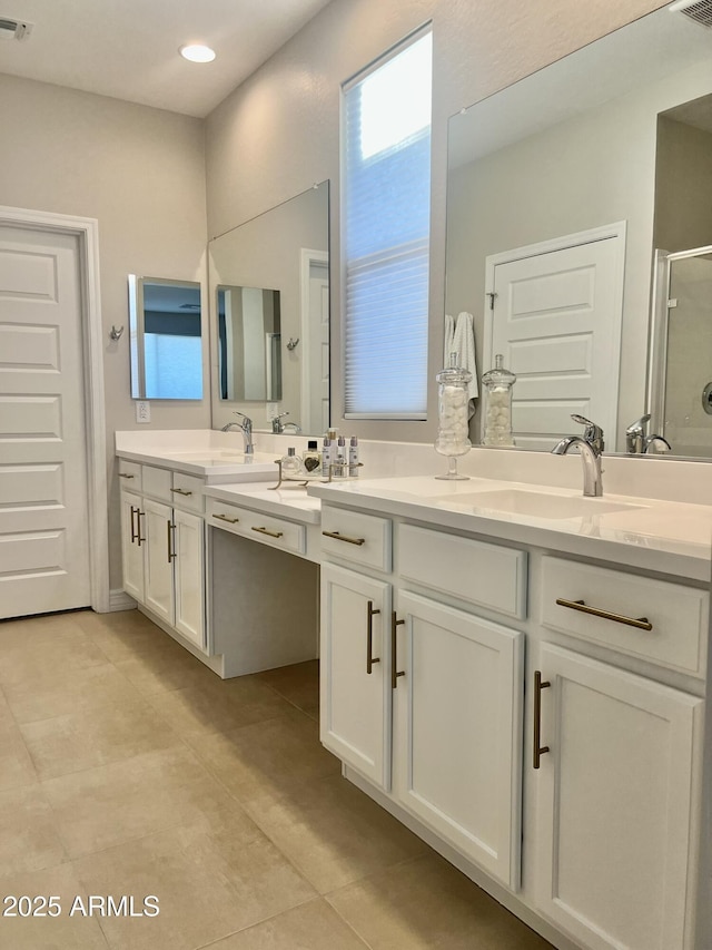 bathroom featuring an enclosed shower, vanity, and tile patterned floors