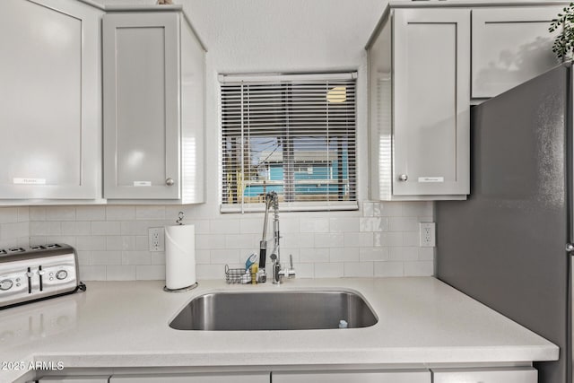 kitchen with sink and decorative backsplash