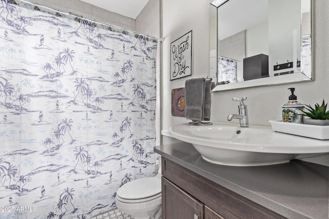 bathroom with vanity, a shower with shower curtain, and toilet