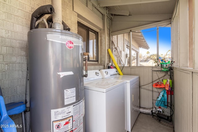 clothes washing area featuring independent washer and dryer and gas water heater