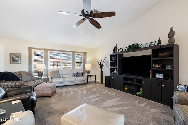 carpeted living room featuring vaulted ceiling and ceiling fan