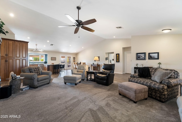 living room featuring lofted ceiling, ceiling fan, and carpet