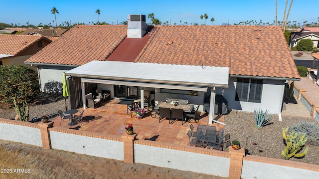 rear view of property with central air condition unit and a patio