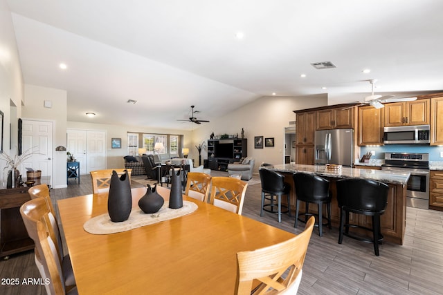 dining space featuring ceiling fan and vaulted ceiling