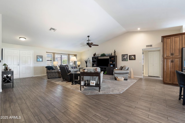 living room featuring ceiling fan and lofted ceiling