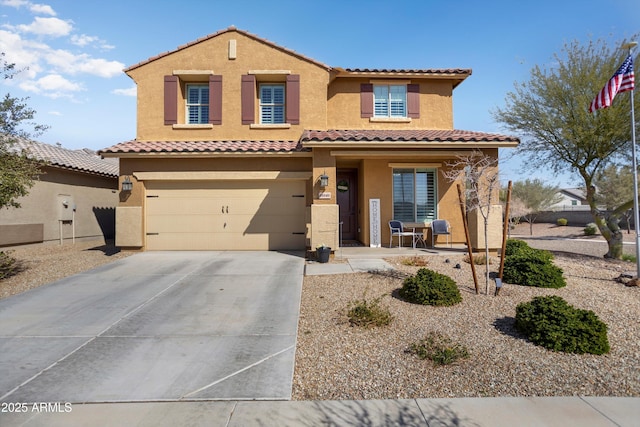 mediterranean / spanish house featuring a tiled roof, concrete driveway, covered porch, stucco siding, and a garage