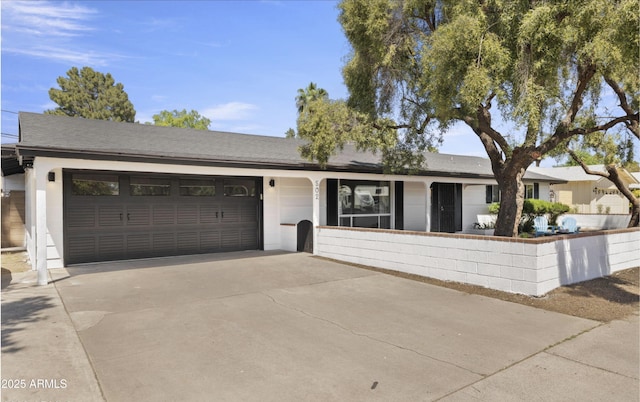 ranch-style home featuring an attached garage and driveway