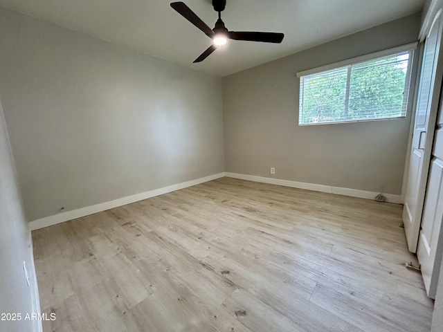 unfurnished room featuring wood finished floors, baseboards, and ceiling fan