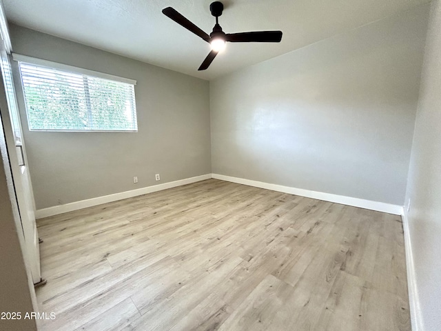 spare room featuring baseboards, a ceiling fan, and wood finished floors