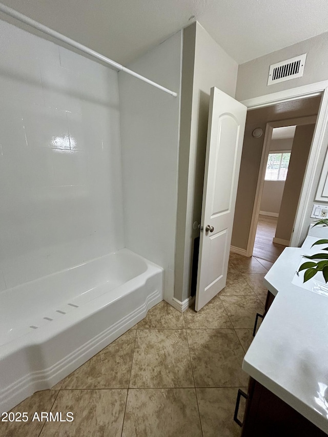 full bathroom featuring baseboards, visible vents, tile patterned flooring, and vanity