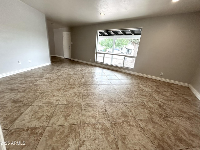 tiled spare room with baseboards and recessed lighting