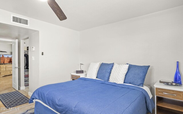 bedroom with baseboards, visible vents, and ceiling fan