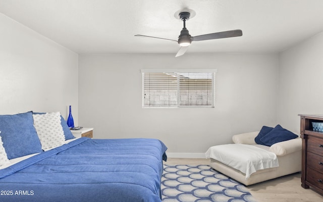 bedroom with light wood-type flooring, baseboards, and ceiling fan