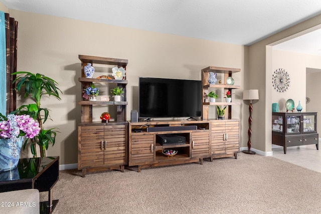 living area with light carpet and baseboards
