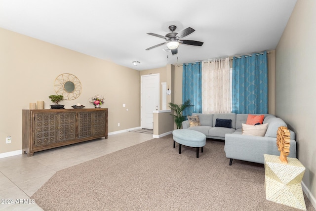 living area featuring tile patterned floors, ceiling fan, and baseboards
