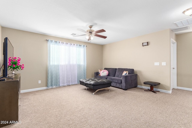 living area with baseboards, ceiling fan, visible vents, and carpet
