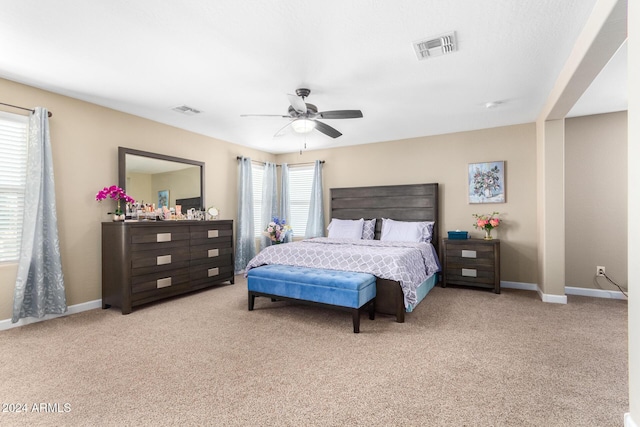 bedroom featuring baseboards, visible vents, carpet, and a ceiling fan