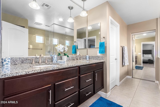 bathroom with visible vents, a sink, a stall shower, and tile patterned flooring