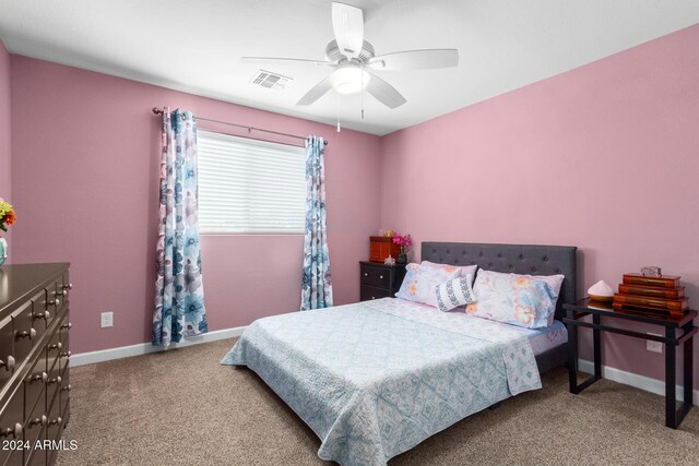 carpeted bedroom featuring baseboards, ceiling fan, and visible vents