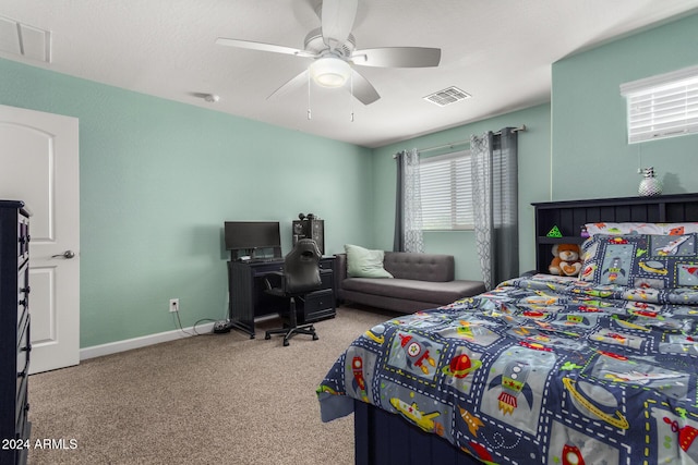 carpeted bedroom featuring baseboards, ceiling fan, and visible vents