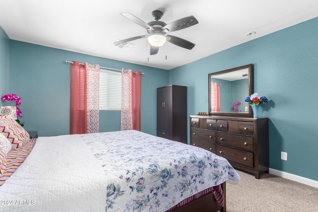 bedroom featuring a ceiling fan, carpet, baseboards, and visible vents