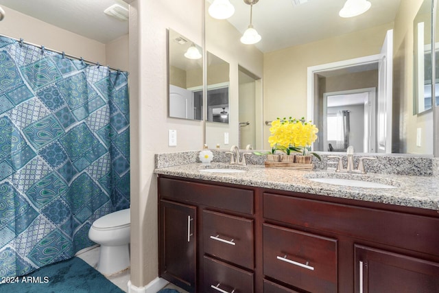 full bath featuring double vanity, visible vents, a sink, and toilet