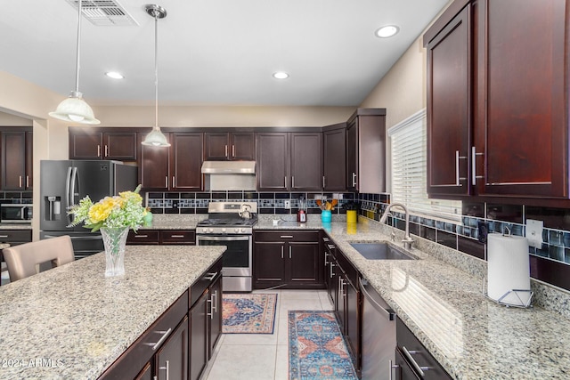 kitchen with light tile patterned floors, stainless steel appliances, under cabinet range hood, backsplash, and a sink