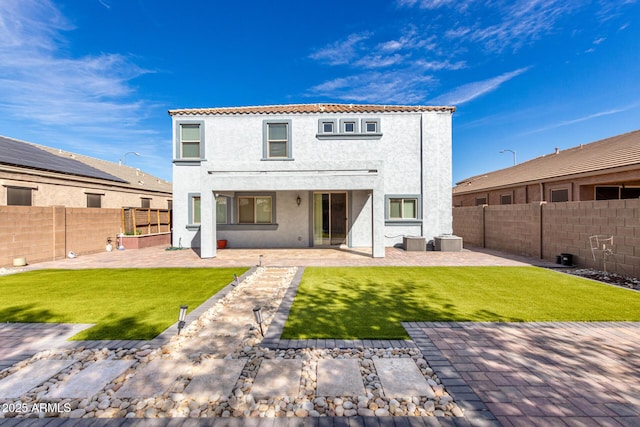 back of house with a fenced backyard, stucco siding, a patio, and central AC