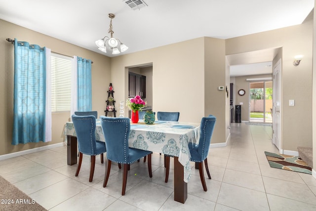 dining area featuring baseboards, visible vents, a notable chandelier, and light tile patterned floors