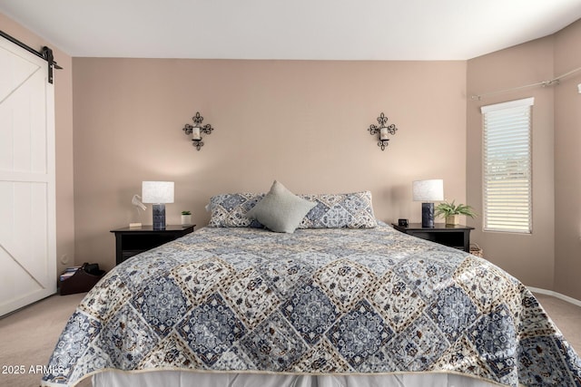 carpeted bedroom featuring a barn door