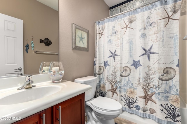 bathroom with vanity, toilet, and curtained shower