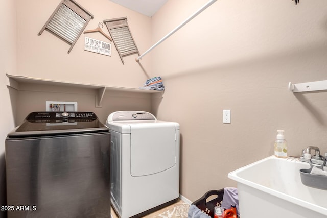 clothes washing area featuring sink and washing machine and dryer