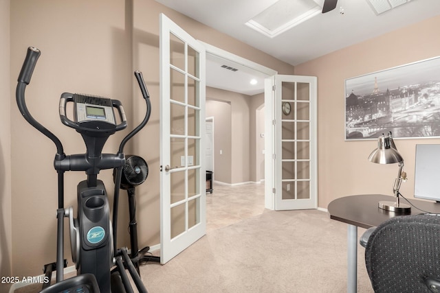 workout room with light colored carpet and french doors