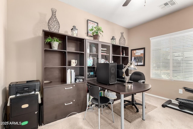 home office featuring light colored carpet and ceiling fan