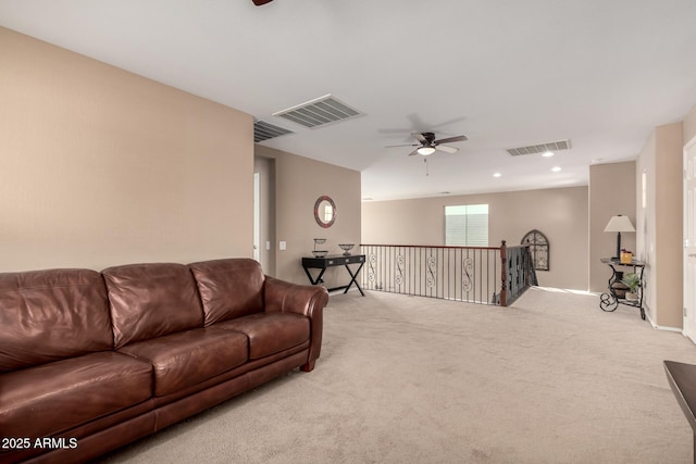 carpeted living room with ceiling fan