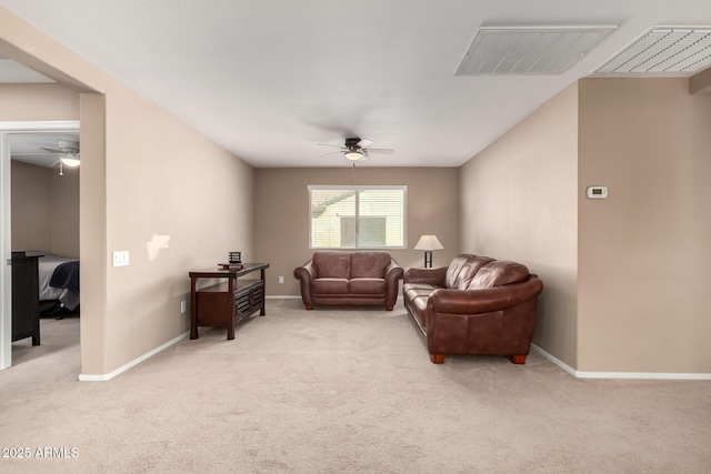 carpeted living room with ceiling fan