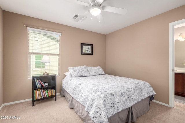 carpeted bedroom featuring ceiling fan and ensuite bathroom