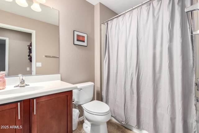 bathroom featuring vanity, tile patterned flooring, and toilet