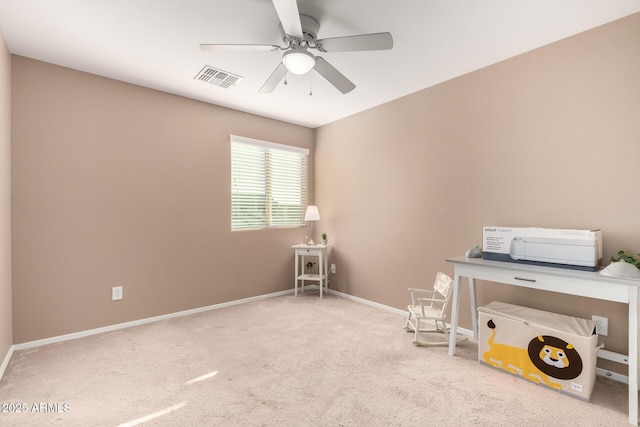 unfurnished office with ceiling fan and light colored carpet