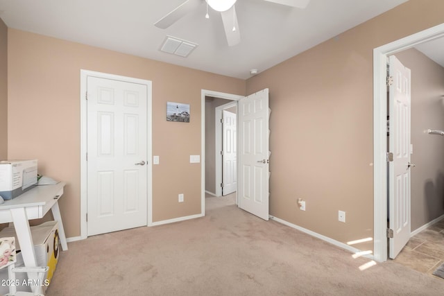 unfurnished bedroom with light colored carpet and ceiling fan