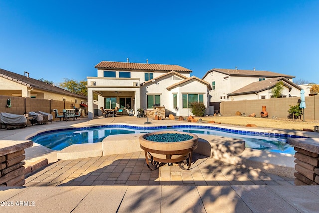 view of pool featuring a patio and a fire pit