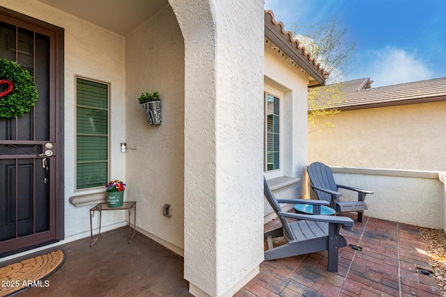 property entrance featuring a patio area