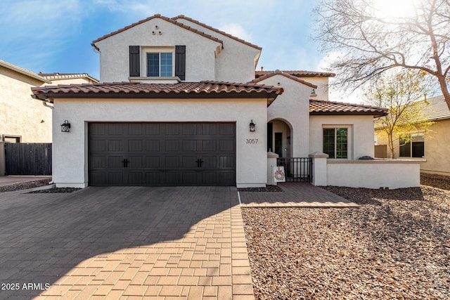 mediterranean / spanish house with a garage