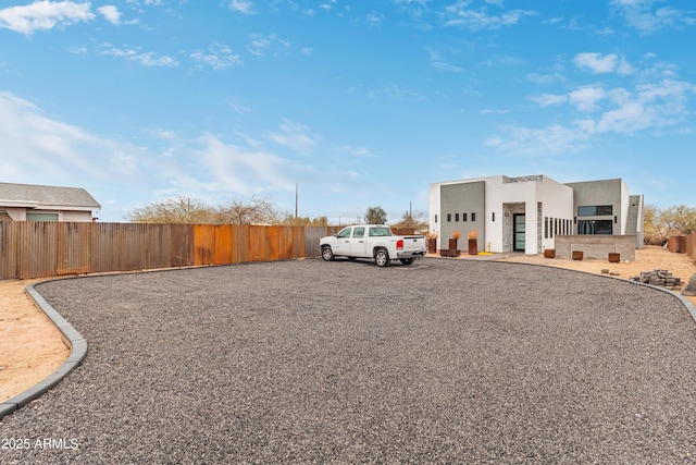 exterior space featuring stucco siding and fence