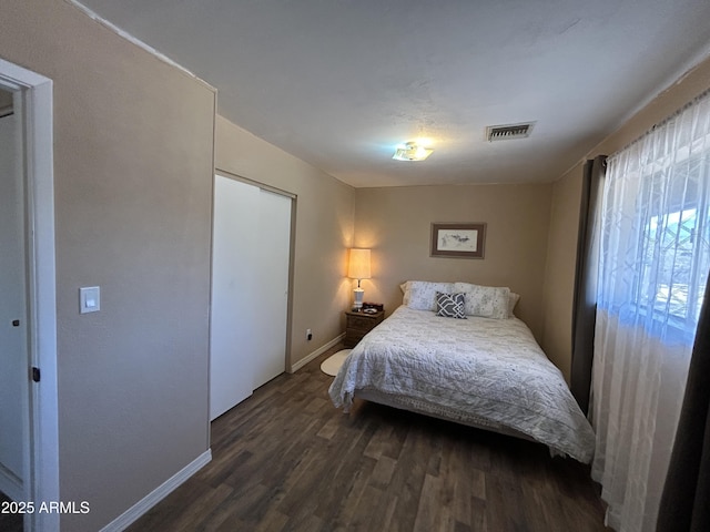 bedroom featuring visible vents, dark wood finished floors, and baseboards