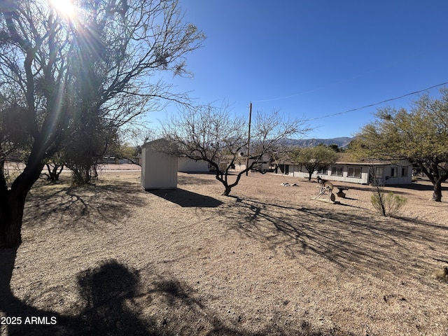 view of yard featuring an outbuilding and a storage unit