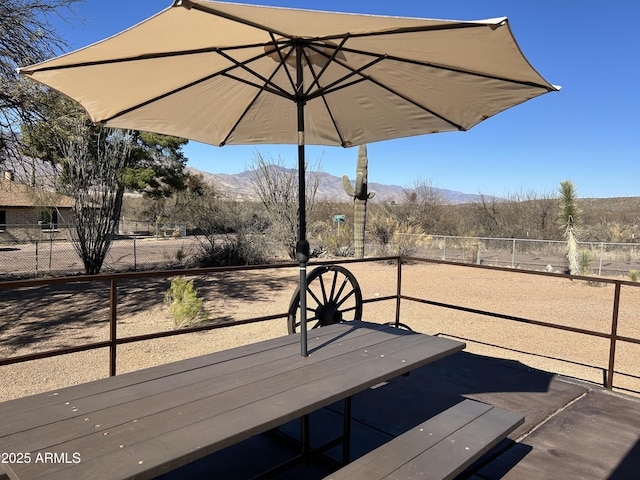 exterior space featuring fence and a mountain view