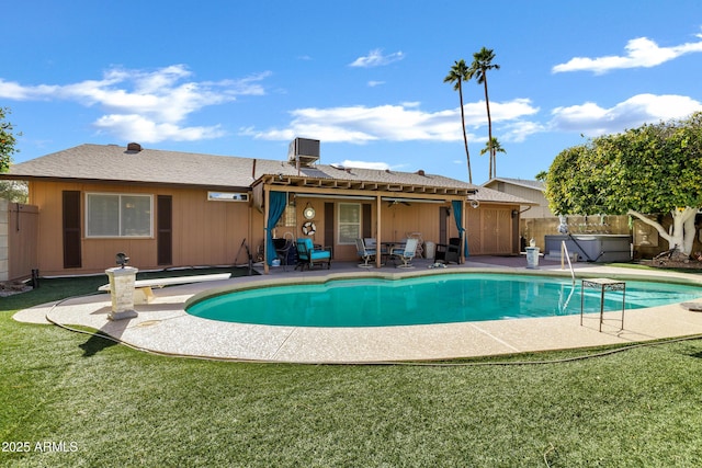 view of pool featuring a hot tub, a patio, a yard, and central AC unit