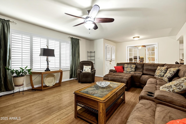 living room featuring hardwood / wood-style flooring and ceiling fan