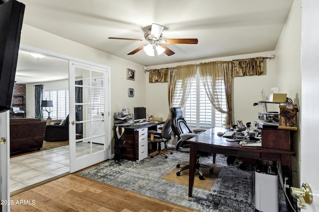 office space featuring french doors, ceiling fan, and light hardwood / wood-style flooring